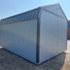 A 10x16 Frontier Shed, stock #0411M41250, with a dark metal roof on dry grass, clear sky above, other sheds in the background.